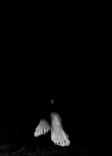 Woman's feet in light & shadow