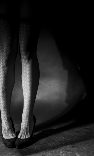 Woman's legs in light & shadow