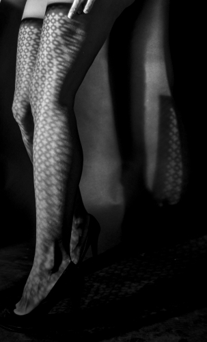 Woman's legs in light & shadow