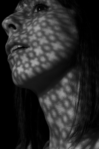Woman's face in light & shadow