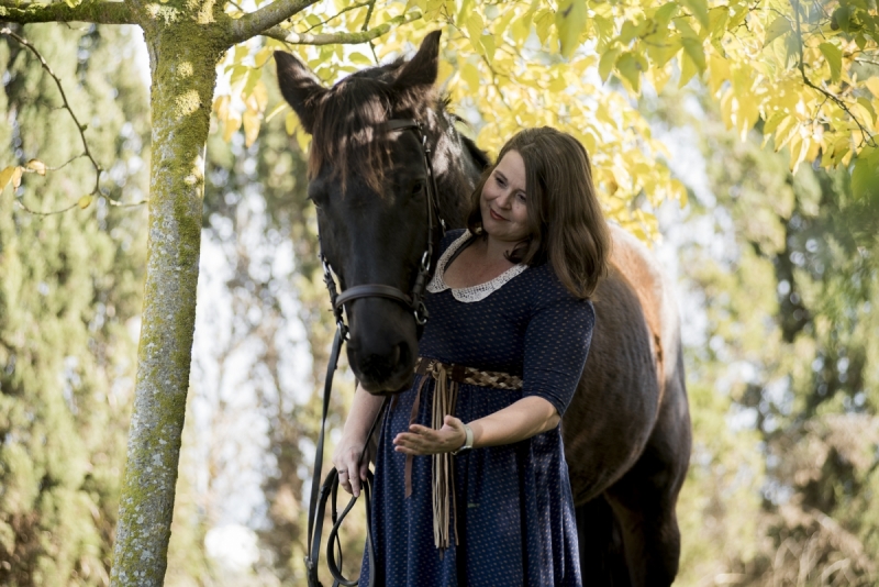Woman with Black Mare amongst Autumn foliage