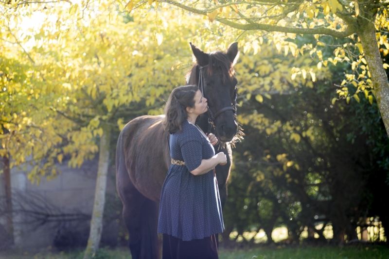 Woman with Black Mare amongst Autumn foliage